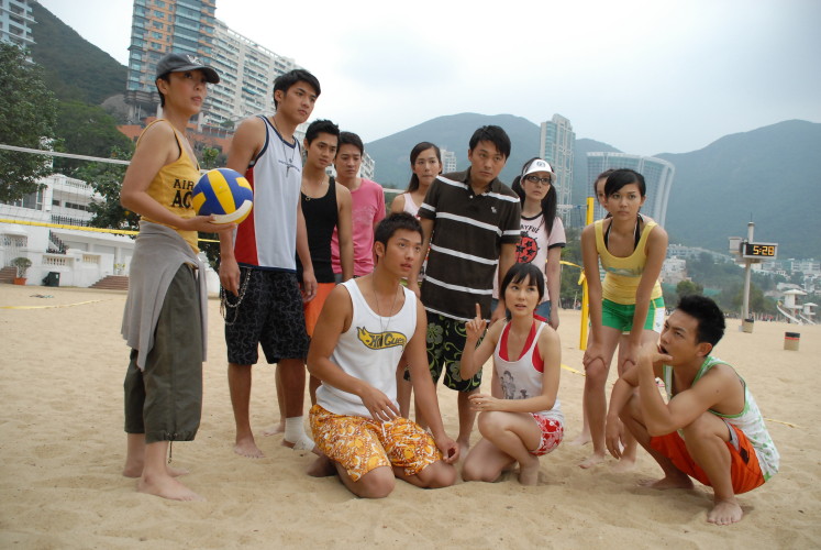 a group of people that are sitting on a beach