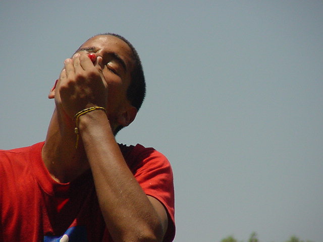 a man with a wristband on and his eyes closed