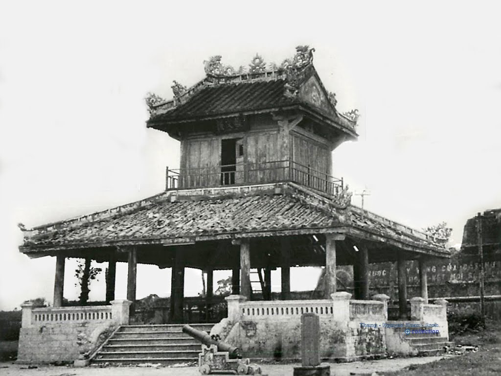 a black and white image of a chinese house in the middle of a city
