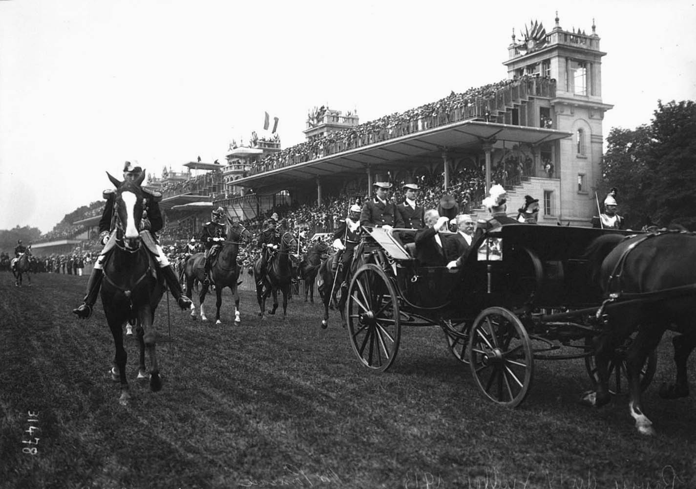 a black and white po of people riding horses