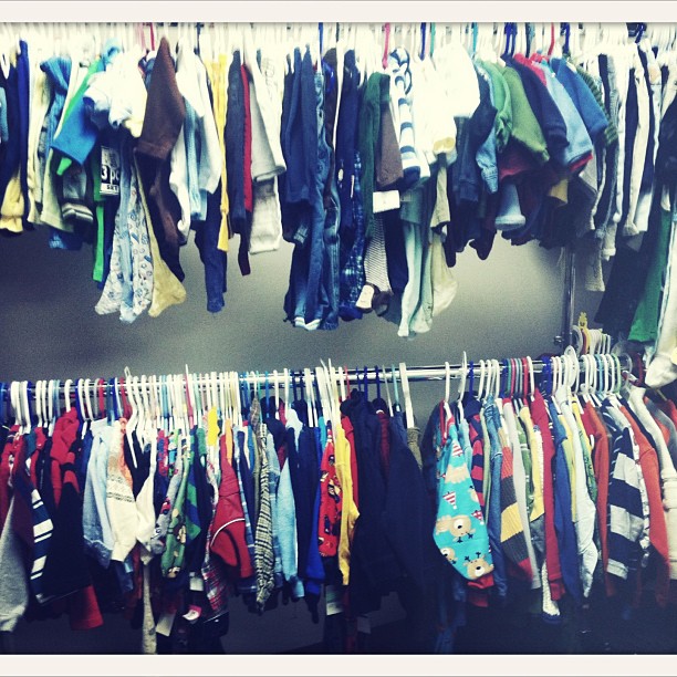 multiple shirts are on a hanger and hung on two racks