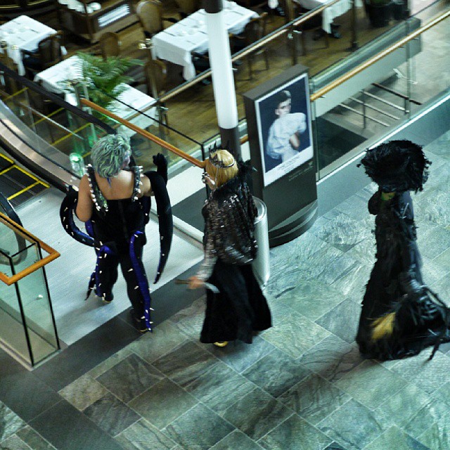 two ladies walking down a stair way in costumes