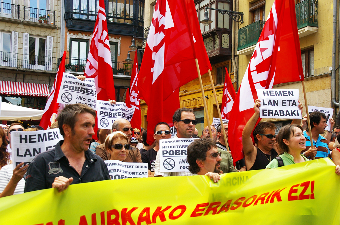 a crowd of people holding signs and flags