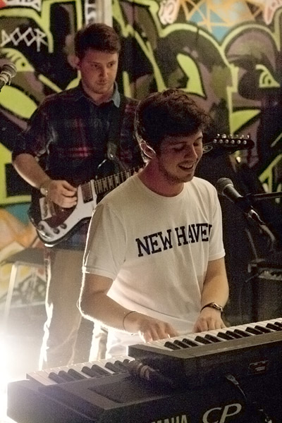 there is a man standing next to a keyboard and guitar