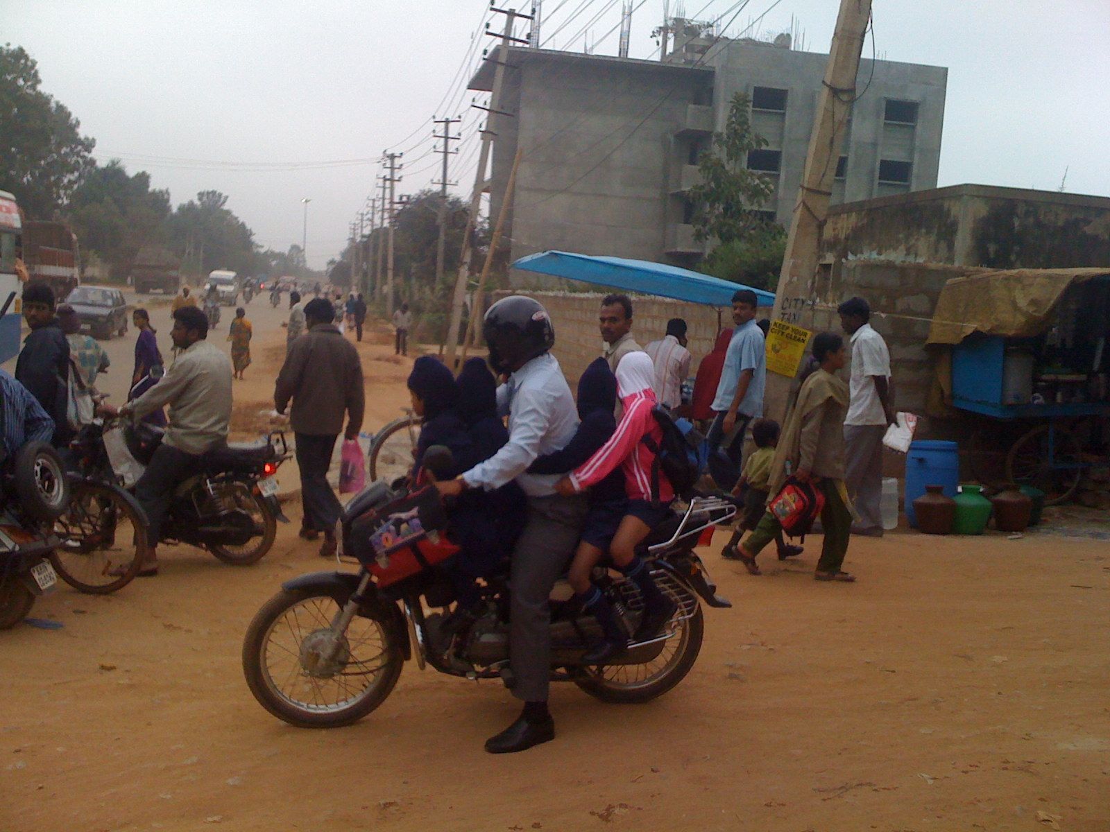 a group of people riding on motorcycles down a street