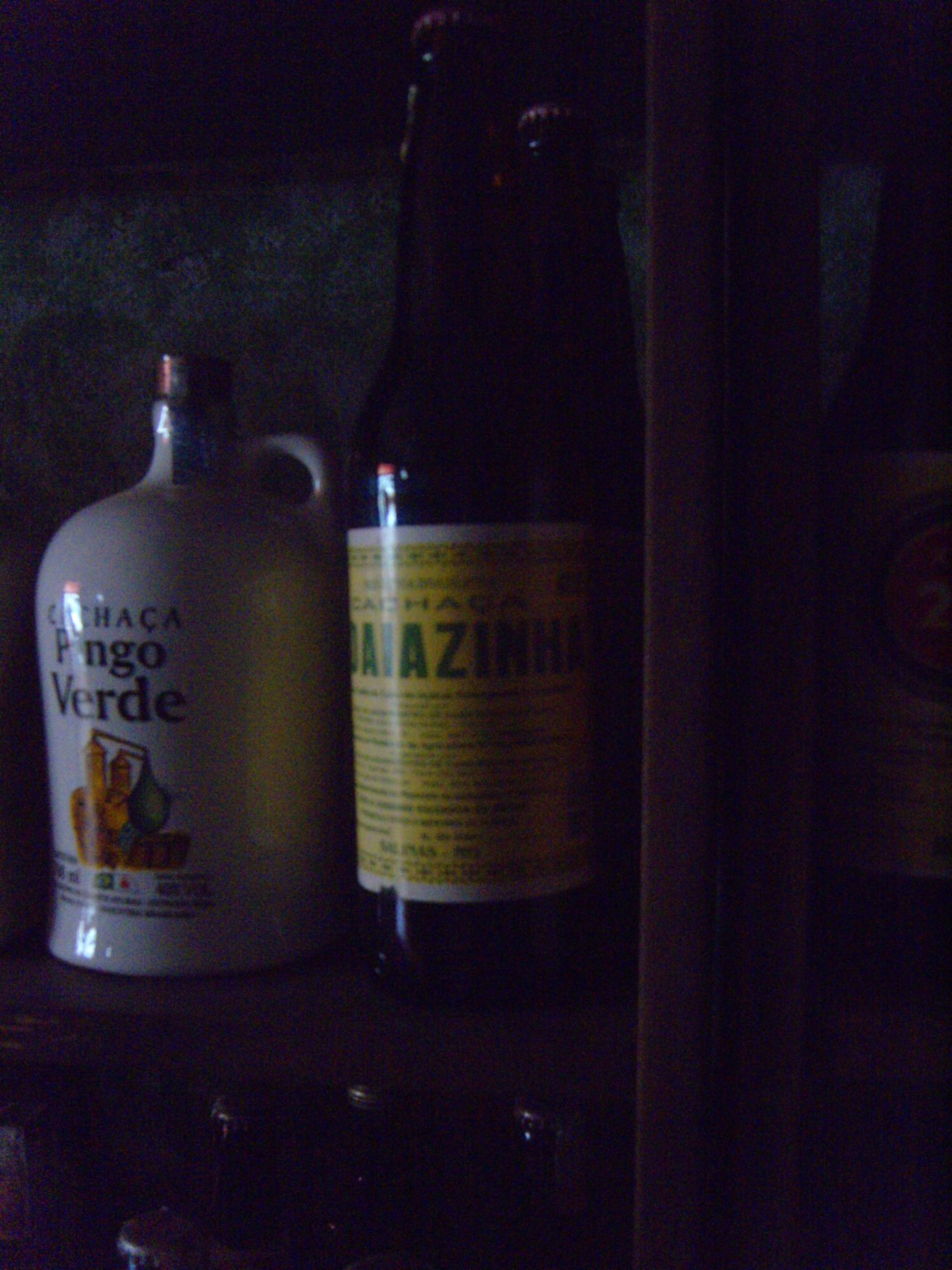 some bottles sit on a shelf and are lit up