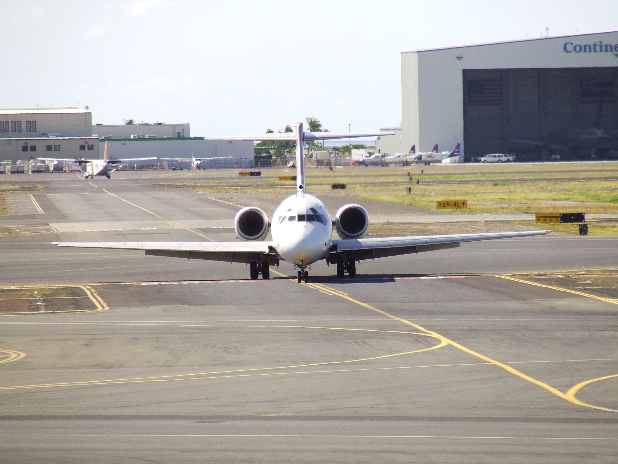 an airplane parked at an airport, in front of the control area