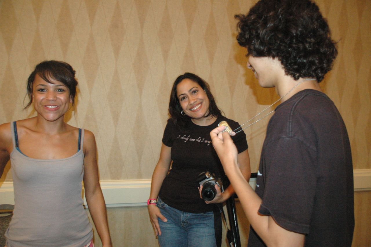 the two girls are laughing together beside a guy