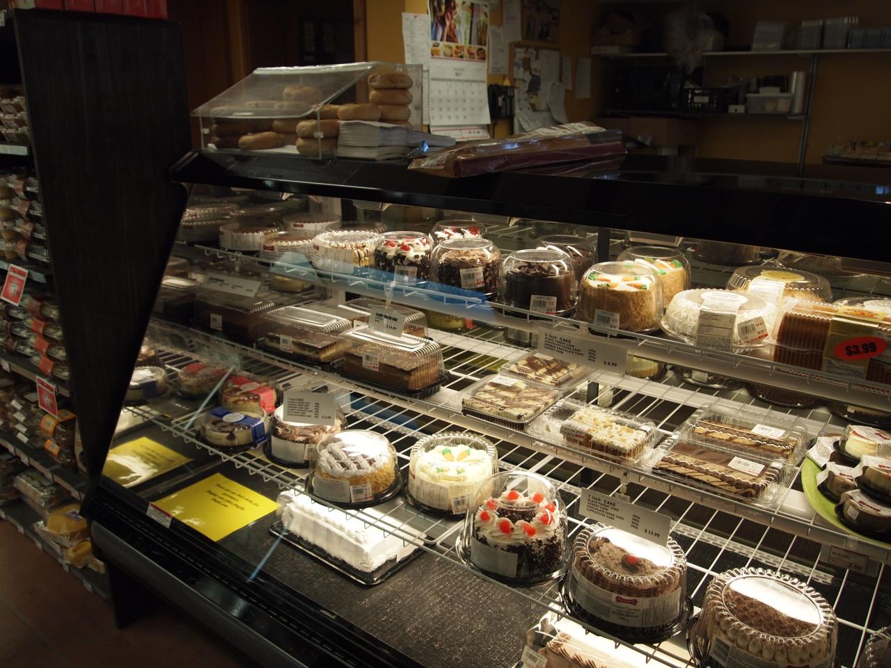 a display case full of deserts inside of a pastry shop