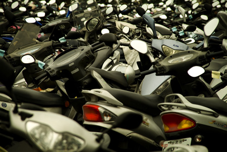 a large amount of motorcycles all lined up in rows
