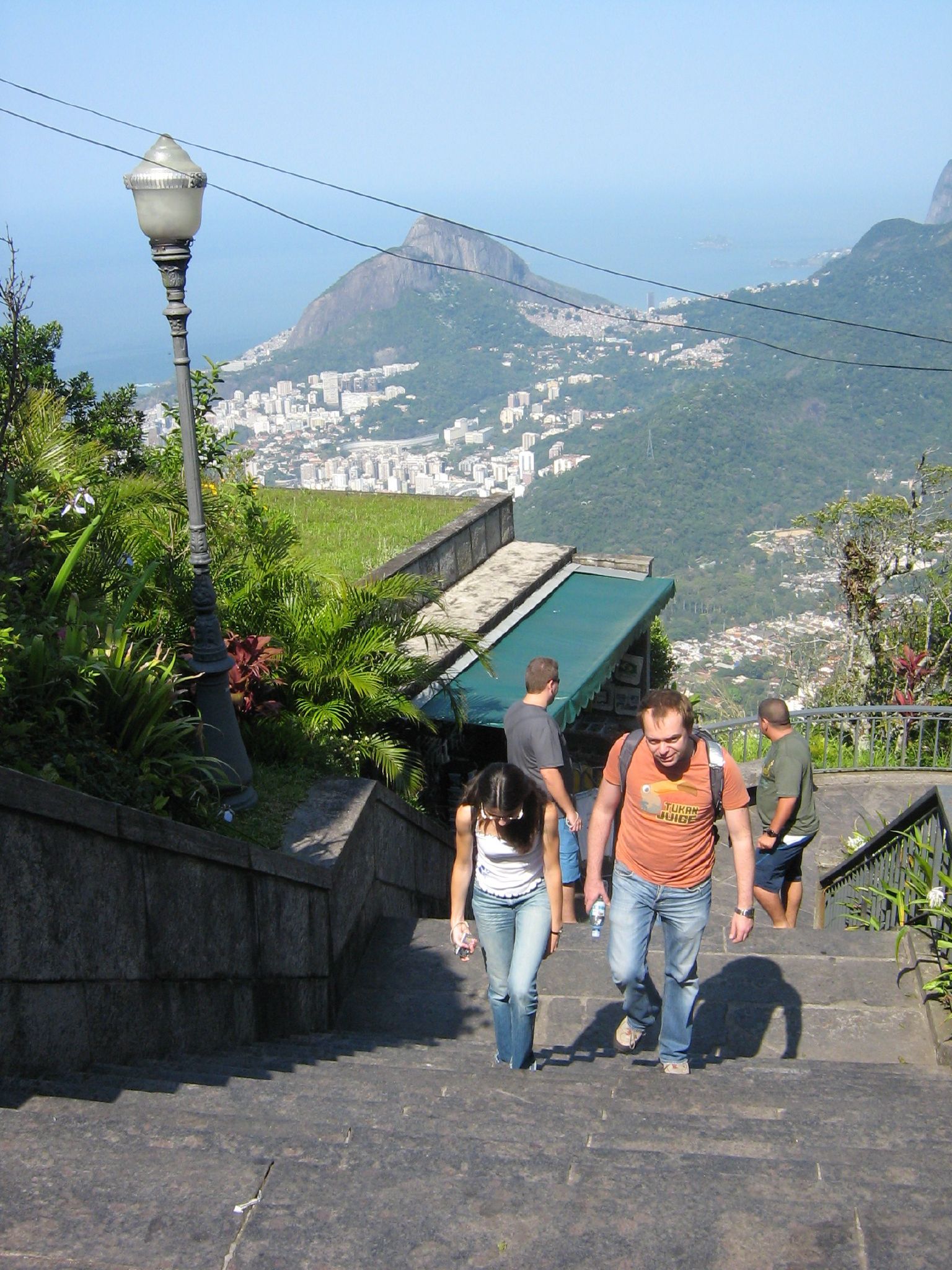 people are walking up a staircase toward a mountain top