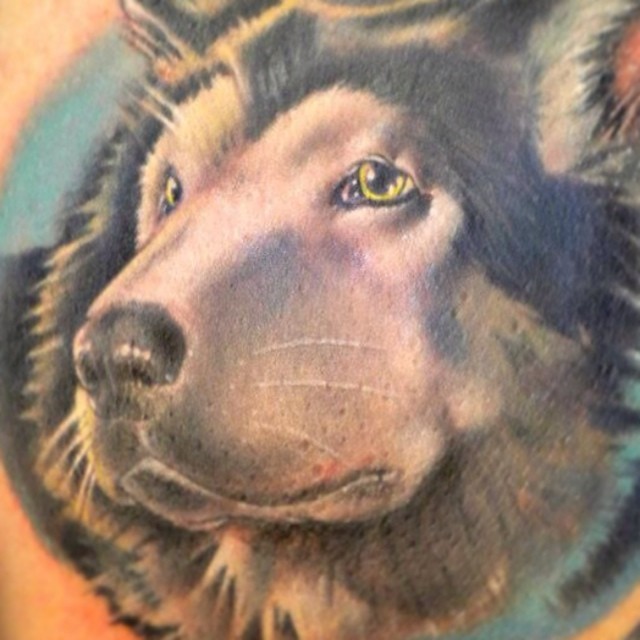 a tattoo of a dog with yellow eyes