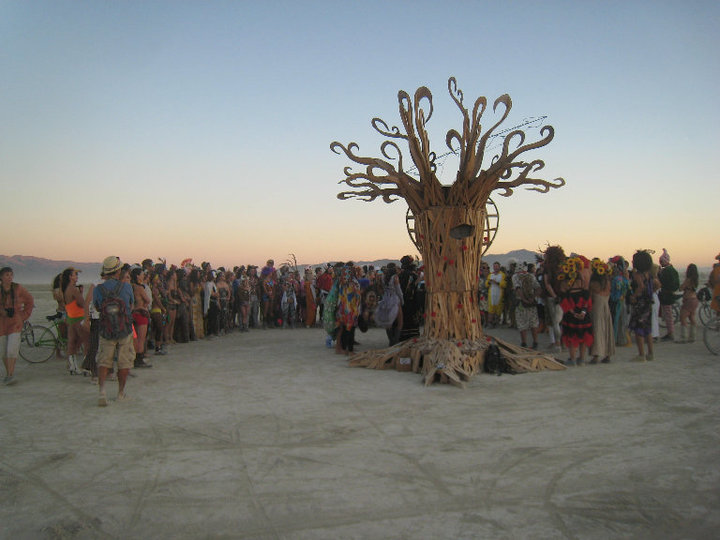 group of people around and standing around a tree