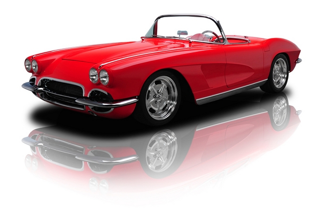 a classic red sports car with the top down