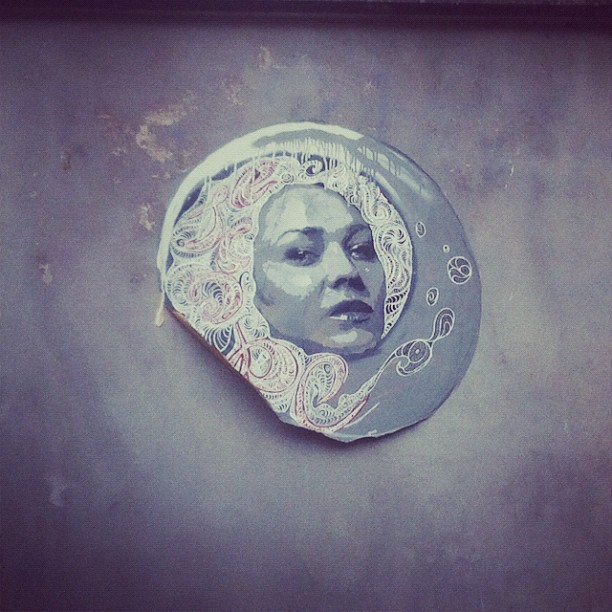 a picture of the moon is hanging on a wall