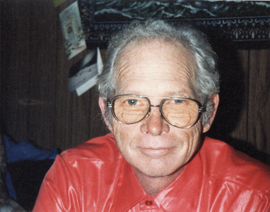 a man wearing glasses and a red shirt