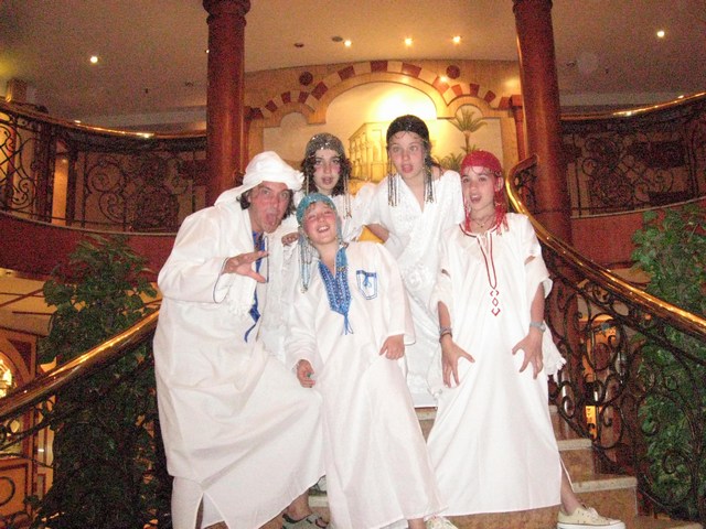 several people dressed in costumes posing on stairs