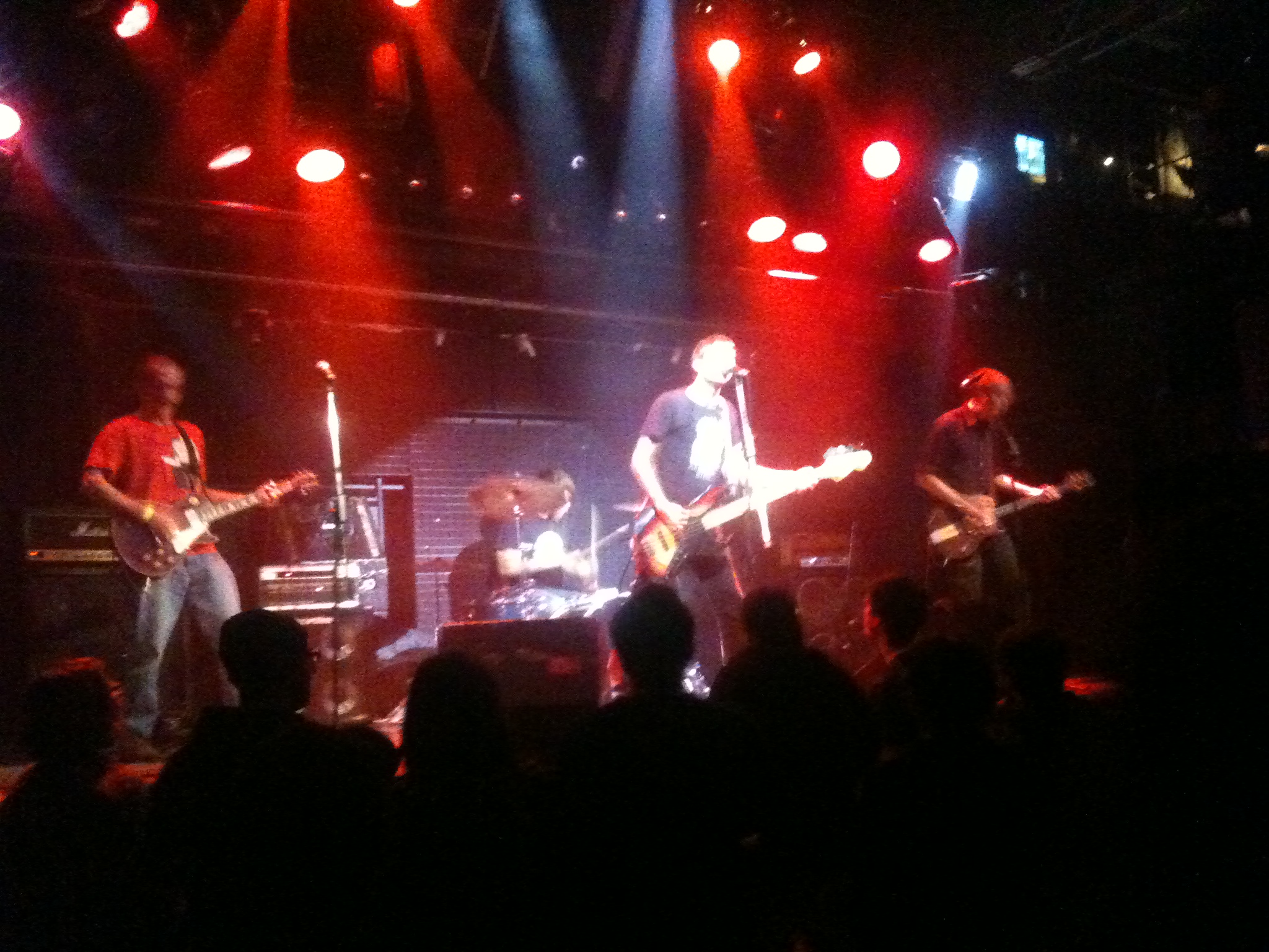 a group of men playing on electric guitars