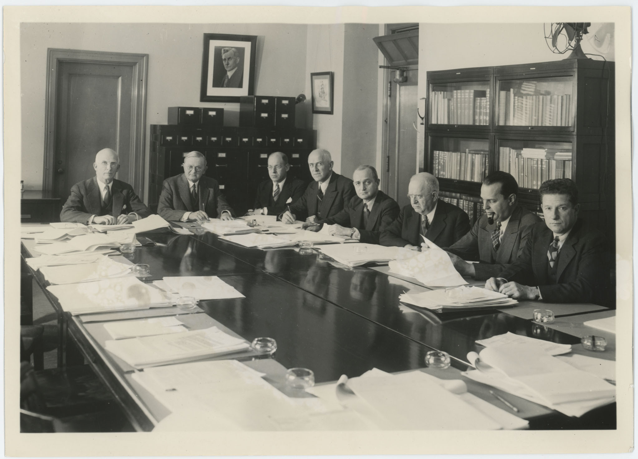 a group of men sitting at a conference table