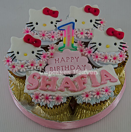 a cup cake decorated with hello kitty decorations