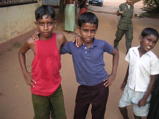 four children standing together outside on the street