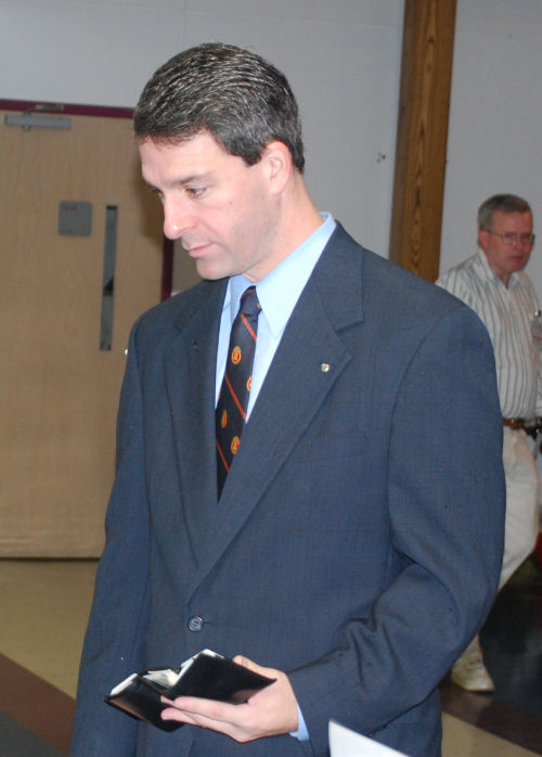 a man in a suit looking over his shoulder