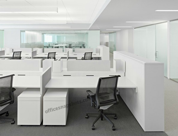 an office cubicle with chairs, desks and file folders
