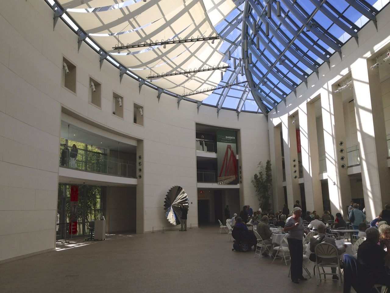 a large atrium filled with people sitting at tables