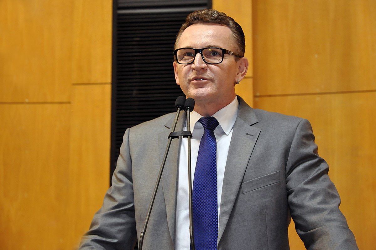 a man wearing glasses giving a speech