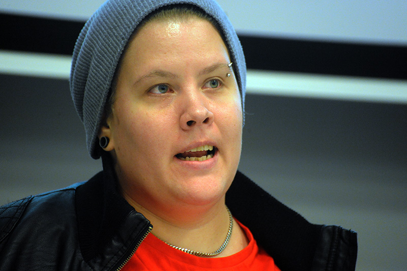 a woman with blue eyes wearing a blue knit hat