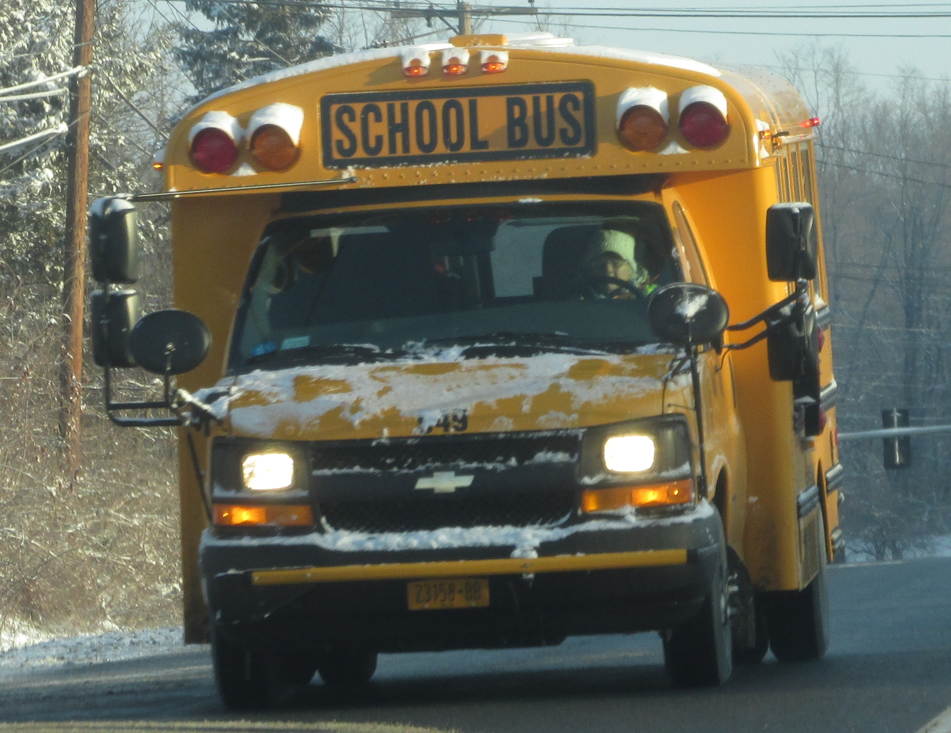 a school bus that is driving in the snow