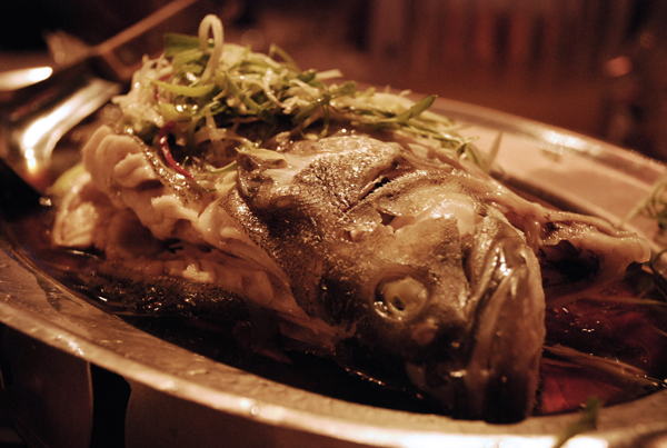 a dish of fish sits on the dining table