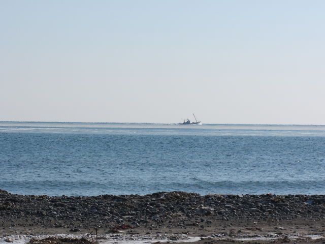 a view of an empty boat sitting on the horizon