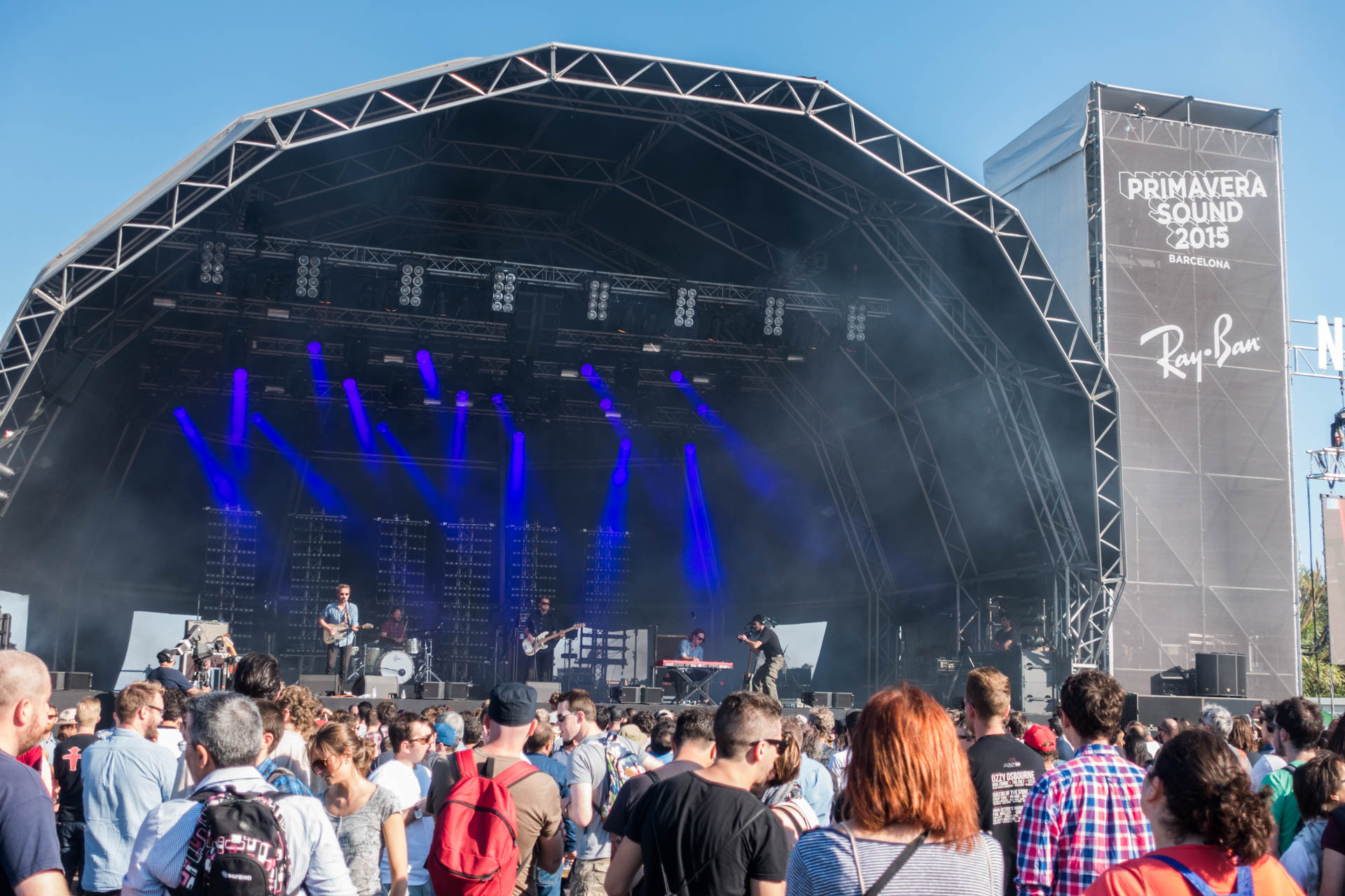 a large crowd is watching a band perform on stage