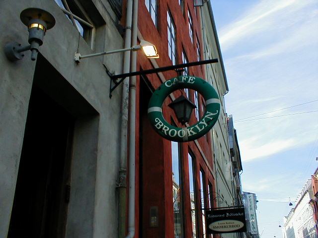a sign for a small bookstore hanging off the side of a building