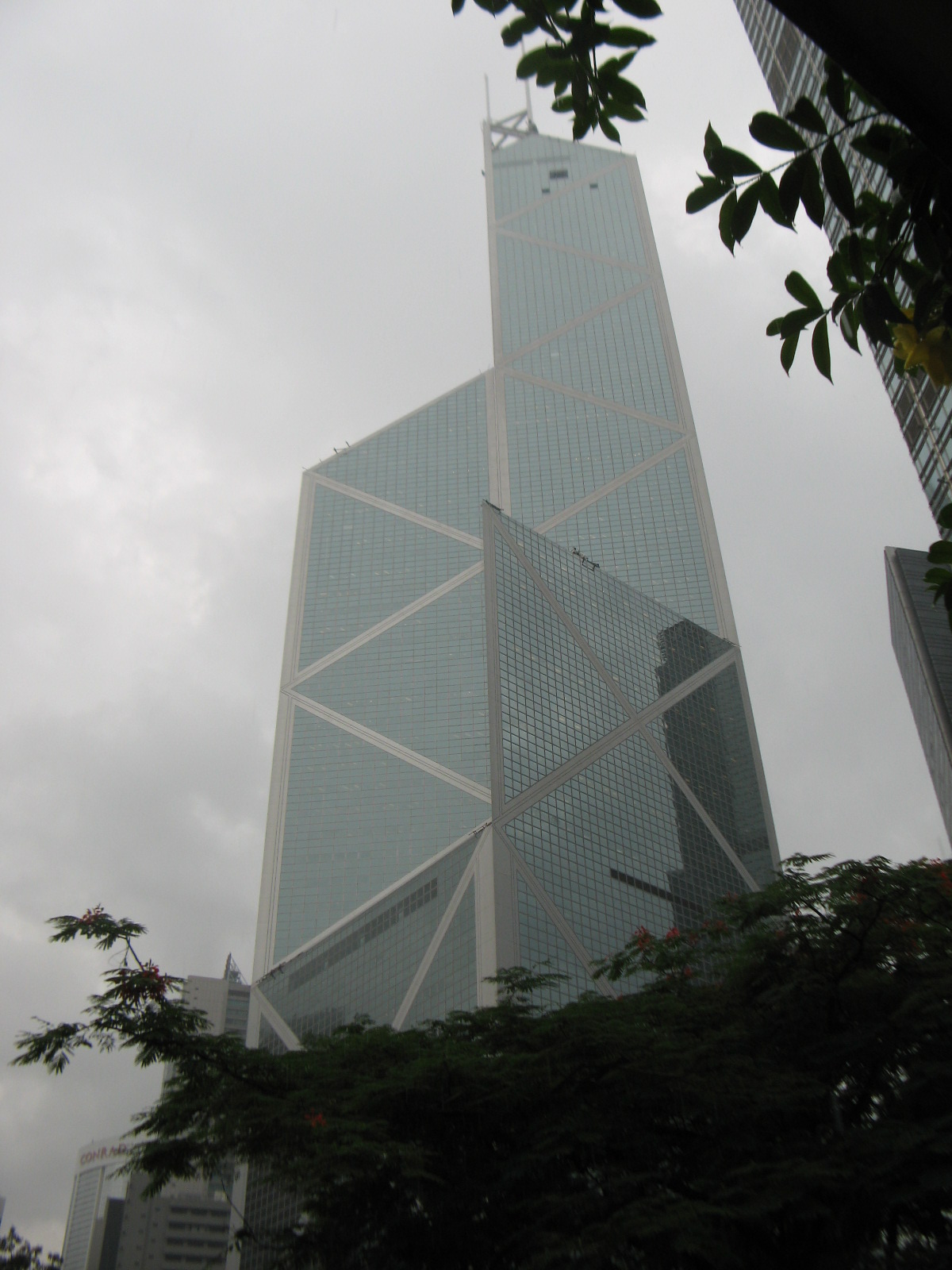 an upward view of a building in the city on a cloudy day