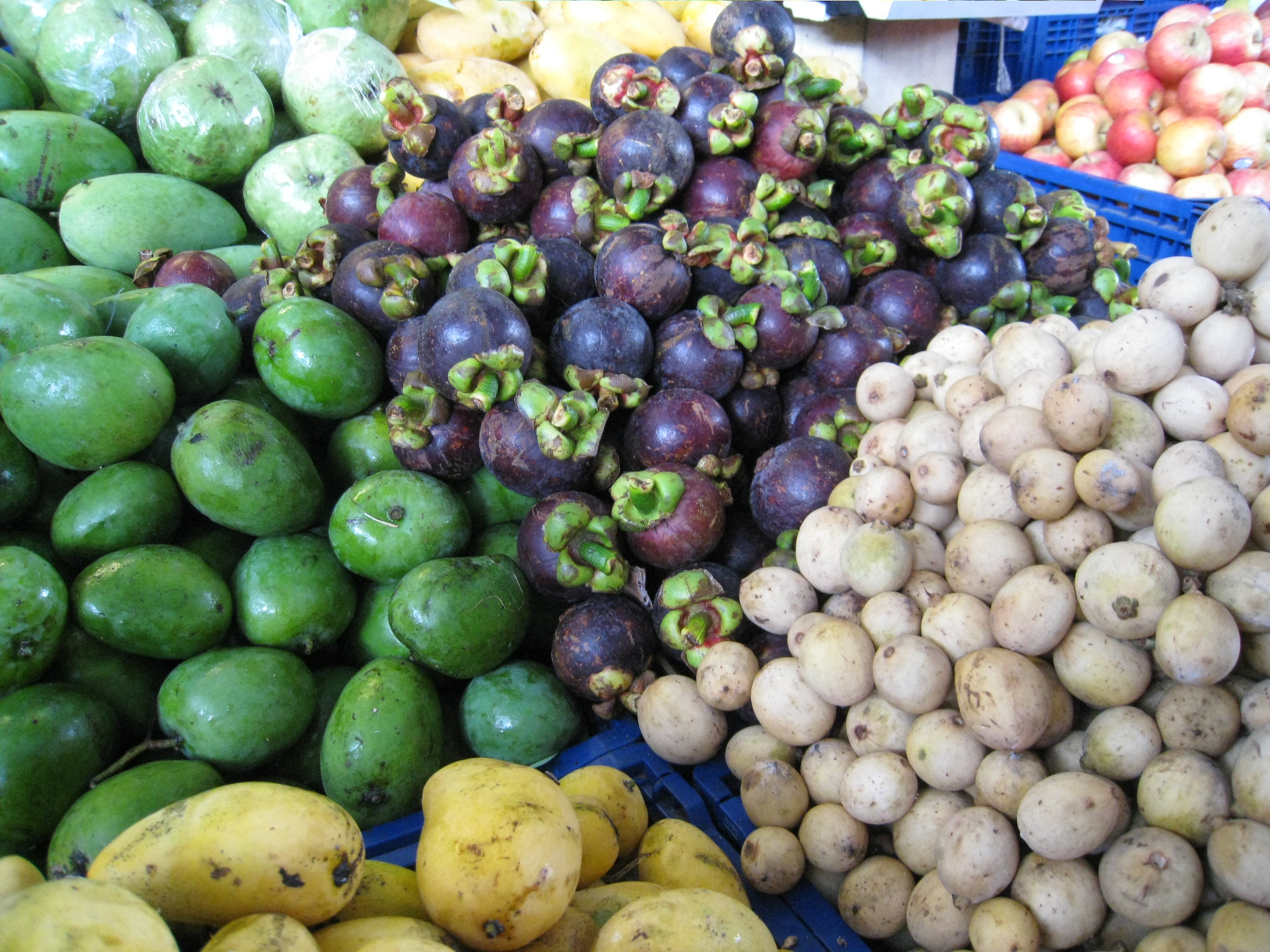 many types of fruits displayed at an outdoor market