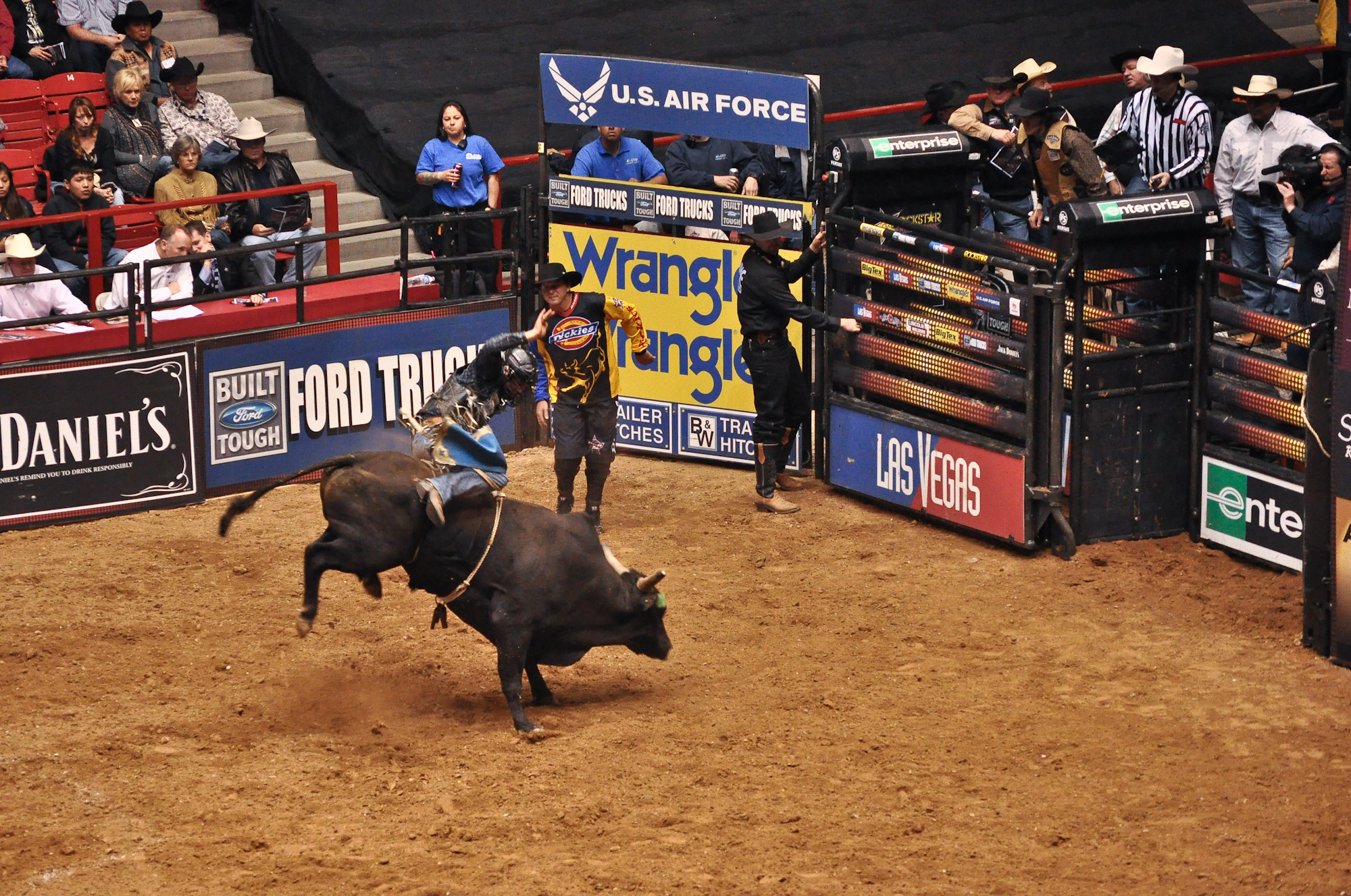 a couple of people on a bull in an arena