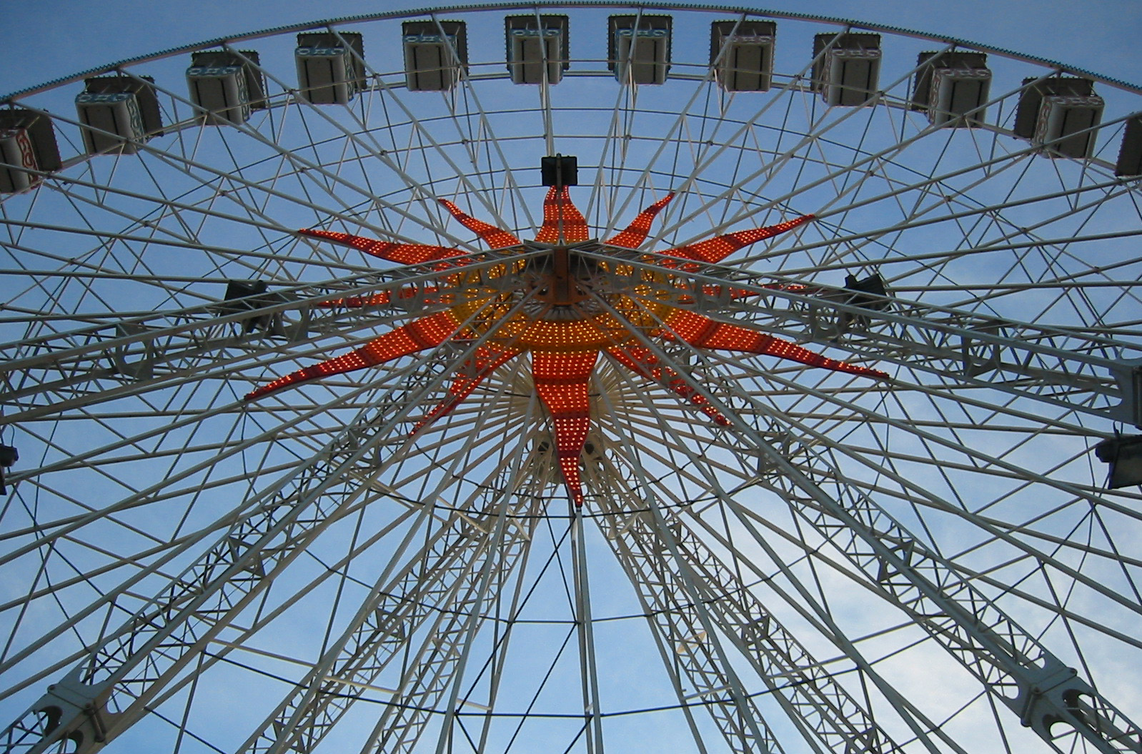 a ferris wheel with six chairs and lights