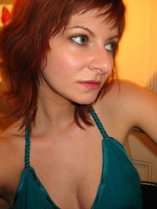 a woman in a blue halter has red hair