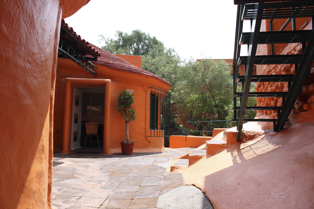 a cement courtyard with steps and orange paint