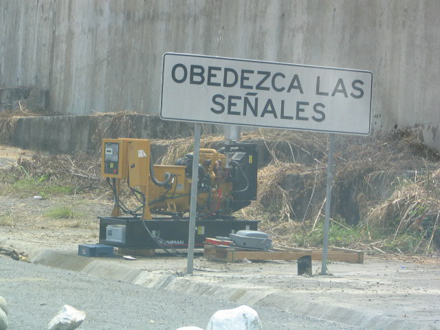 a road sign near a construction site that is near a building
