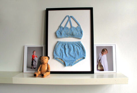 a framed po and teddy bear sitting on a shelf
