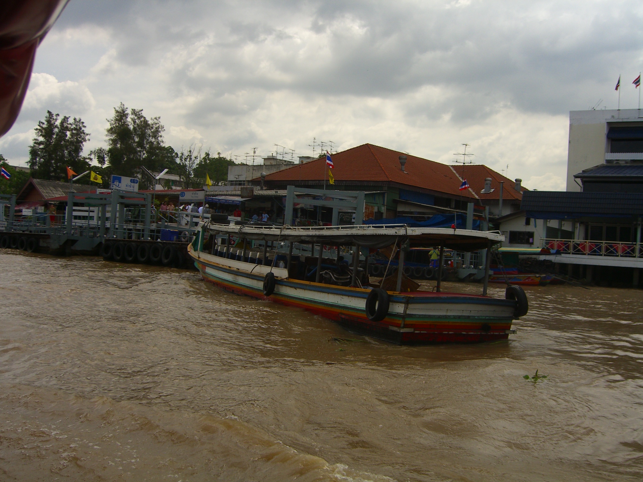 two boats on the water in front of buildings