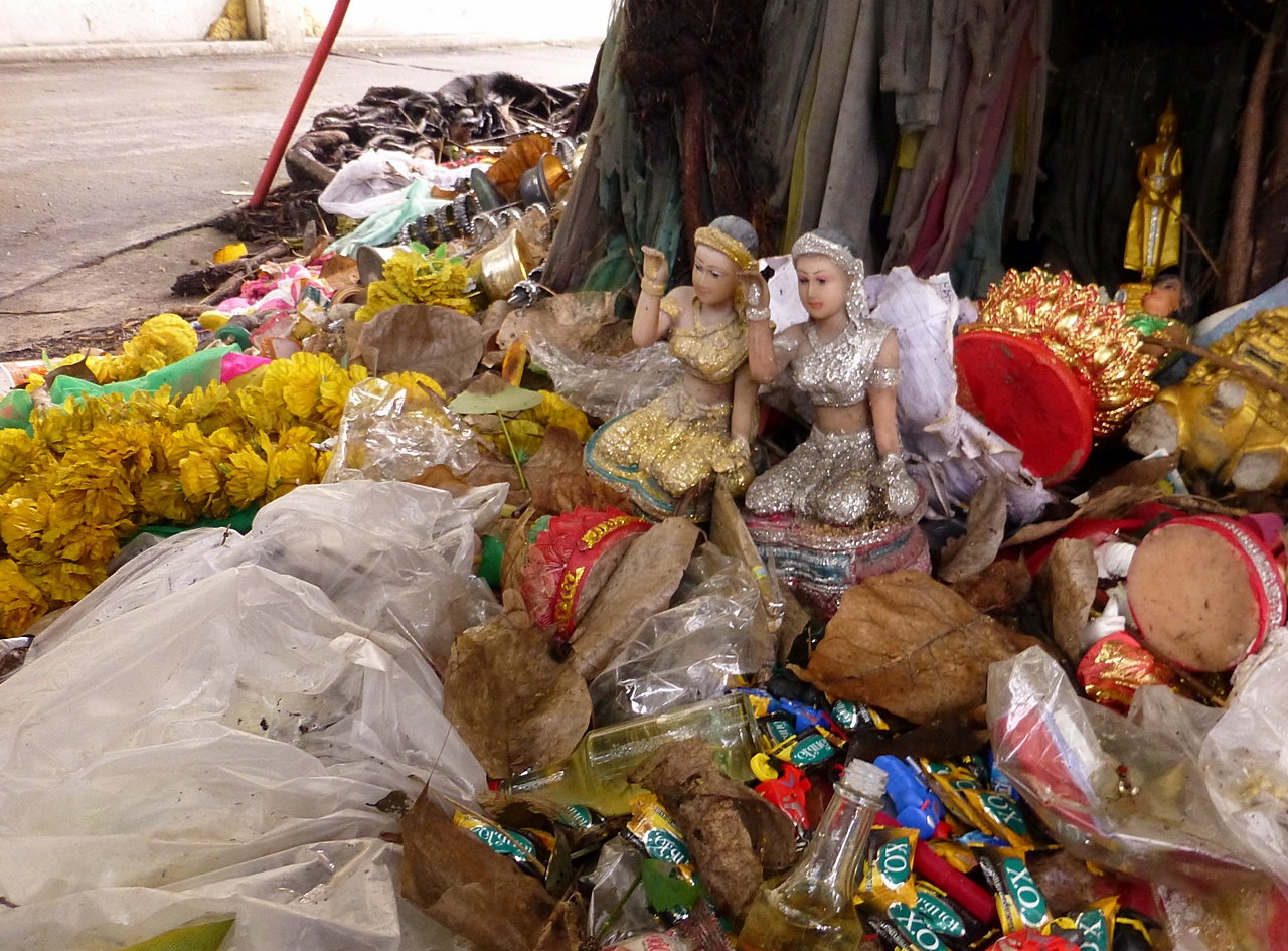 many plastic dolls sit next to a pile of food items