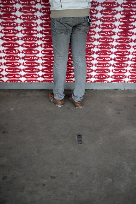 a person standing in front of a wall holding a box