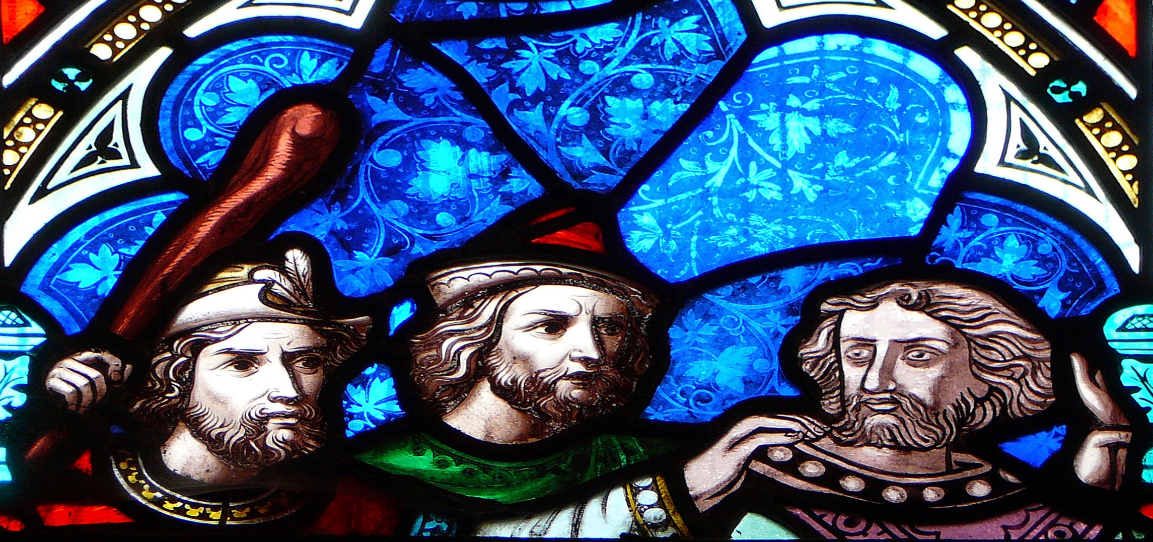 a stained glass window with two medieval men