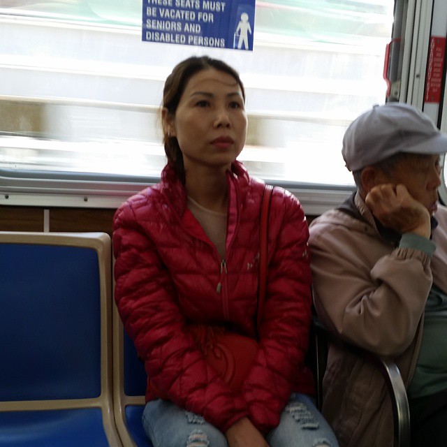two women sitting on a train looking off into the distance