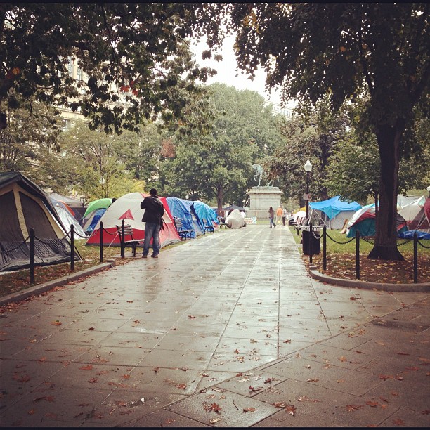 many tents with people in them outside by the trees