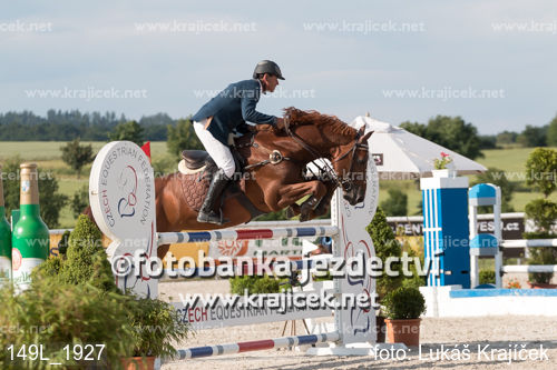 a horse is jumping over a barrel at the equestrian event